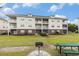 Condo building with outdoor grill and picnic table on a sunny day at 604 Heathrow Dr. # 1101, Myrtle Beach, SC 29579