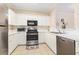 Bright kitchen with white cabinetry and stainless steel appliances at 604 Heathrow Dr. # 1101, Myrtle Beach, SC 29579