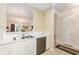 Galley kitchen featuring stainless steel dishwasher, double sink, and a pass through window to the dining area at 604 Heathrow Dr. # 1101, Myrtle Beach, SC 29579