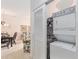 Laundry closet includes stacked washer and dryer located near the dining and living spaces at 604 Heathrow Dr. # 1101, Myrtle Beach, SC 29579