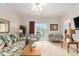 Cozy living room with bright lighting, ceiling fan, and access to balcony at 604 Heathrow Dr. # 1101, Myrtle Beach, SC 29579