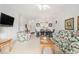 Open-concept living room featuring dining area and floral-patterned furniture at 604 Heathrow Dr. # 1101, Myrtle Beach, SC 29579