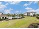 View of a community pool surrounded by lush landscaping and nearby buildings at 604 Heathrow Dr. # 1101, Myrtle Beach, SC 29579