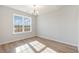 Sunny dining room featuring hardwood floors, a modern chandelier, and large windows at 605 Lightwood Dr., Conway, SC 29526