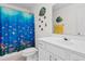 Bright bathroom featuring seashell-themed shower curtain and marine-themed wall decor at 613B 3Rd Ave. S, North Myrtle Beach, SC 29582