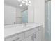 Well-lit bathroom featuring a white vanity with modern fixtures and seashell-themed shower curtain at 613B 3Rd Ave. S, North Myrtle Beach, SC 29582