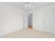 Bright bedroom featuring neutral carpet, a ceiling fan, and a door to another room at 613B 3Rd Ave. S, North Myrtle Beach, SC 29582