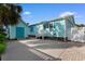 Charming home features an attached garage, a fenced yard, and a bright turquoise color scheme at 613B 3Rd Ave. S, North Myrtle Beach, SC 29582