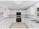 Bright, modern kitchen with white cabinets and stainless steel appliances at 613B 3Rd Ave. S, North Myrtle Beach, SC 29582