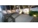 Relaxing backyard patio features lighting, palm trees, white fencing, and serene water feature at 613B 3Rd Ave. S, North Myrtle Beach, SC 29582