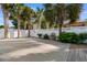 Inviting patio features white fencing, palm trees, and a water fountain, perfect for outdoor relaxation at 613B 3Rd Ave. S, North Myrtle Beach, SC 29582