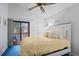 Bright bedroom with a ceiling fan, blue carpet, and sliding glass doors to the balcony at 614 15Th Ave. S # 41, Surfside Beach, SC 29575