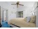 This bedroom is decorated with a ceiling fan, white walls, blue carpet, and a view of the balcony at 614 15Th Ave. S # 41, Surfside Beach, SC 29575