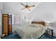 Bedroom features a ceiling fan, a window, and a bed with a patterned blue comforter at 614 15Th Ave. S # 41, Surfside Beach, SC 29575