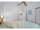 Bright bedroom with a ceiling fan and bed decorated with a blue and white comforter at 614 15Th Ave. S # 41, Surfside Beach, SC 29575