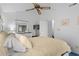 The bedroom is decorated with a ceiling fan, white walls, blue carpet, and a TV at 614 15Th Ave. S # 41, Surfside Beach, SC 29575
