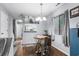Charming dining area featuring wood floors, a modern chandelier, and plenty of natural light at 614 15Th Ave. S # 41, Surfside Beach, SC 29575