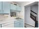 Well-maintained kitchen featuring blue cabinets with a view to the living area at 614 15Th Ave. S # 41, Surfside Beach, SC 29575