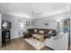 Spacious living area with hardwood floors, ceiling fan, and a comfy brown sectional couch at 614 15Th Ave. S # 41, Surfside Beach, SC 29575