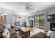 Open-concept living space with hardwood floors, ceiling fan, and sliding door to outdoor space at 614 15Th Ave. S # 41, Surfside Beach, SC 29575