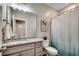 This bathroom has gray cabinets, granite countertop, a framed mirror, and a shower with curtain at 620 Lorenzo Dr. # 620, North Myrtle Beach, SC 29582
