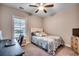 This bedroom is decorated with a coastal theme and has a ceiling fan, window, desk, and carpeting at 620 Lorenzo Dr. # 620, North Myrtle Beach, SC 29582
