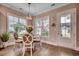 Dining area with a chandelier and a round table with seating, and abundant natural light from the windows at 620 Lorenzo Dr. # 620, North Myrtle Beach, SC 29582