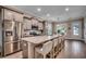 Bright kitchen with large island featuring seating, stainless steel appliances, and elegant wood flooring at 620 Lorenzo Dr. # 620, North Myrtle Beach, SC 29582