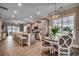 Open-concept kitchen boasts a large island with seating, granite countertops, stainless steel appliances, and wood flooring at 620 Lorenzo Dr. # 620, North Myrtle Beach, SC 29582