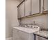 Functional laundry room with gray cabinets, granite countertop, and a modern washer and dryer at 620 Lorenzo Dr. # 620, North Myrtle Beach, SC 29582