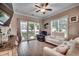 Cozy living room with a ceiling fan, sliding glass doors, and neutral-toned furniture at 620 Lorenzo Dr. # 620, North Myrtle Beach, SC 29582