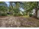 Large backyard with mature trees, shrubs, and open grassy area at 64 Bamboo Loop # 161, Georgetown, SC 29440