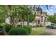 Serene condo exterior with mature trees, golf cart, and private entrance at 64 Bamboo Loop # 161, Georgetown, SC 29440