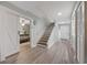 Bright foyer with wood-look floors, staircase, and charming sliding barn door to bedroom at 64 Bamboo Loop # 161, Georgetown, SC 29440