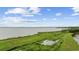 Aerial view showcasing the complex's large grassy space near the waterway at 64 Bamboo Loop # 161, Georgetown, SC 29440