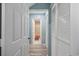 Hallway with neutral paint and flooring connects the bedrooms and bathroom areas at 64 Bamboo Loop # 161, Georgetown, SC 29440