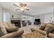 Bright and airy living room with ceiling fan and fireplace, connecting the living spaces at 64 Bamboo Loop # 161, Georgetown, SC 29440