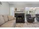 Cozy living room with a fireplace, ample seating, and access to a screened-in porch at 64 Bamboo Loop # 161, Georgetown, SC 29440