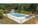 Outdoor pool surrounded by lounge furniture, fencing, and a pool house at 64 Bamboo Loop # 161, Georgetown, SC 29440