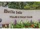 Belle Isle Villas & Yacht Club sign surrounded by colorful flowers and lush greenery at 64 Bamboo Loop # 161, Georgetown, SC 29440