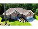 An aerial view captures this brick home with a two-car garage, complemented by its landscaped surroundings in a lush setting at 6572 Wellington Dr., Murrells Inlet, SC 29576