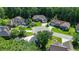 An aerial view reveals a home with lush surroundings in a cul-de-sac, next to other manicured lawns and mature trees at 6572 Wellington Dr., Murrells Inlet, SC 29576