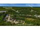 Aerial view showcases a community near a golf course and river, with lush greenery and well-maintained homes, ideal for recreation at 6572 Wellington Dr., Murrells Inlet, SC 29576