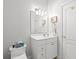 Bright white bathroom with a toilet and sink with cabinet space at 6572 Wellington Dr., Murrells Inlet, SC 29576