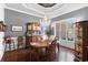 The dining room boasts a chandelier, a wooden table, and large windows at 6572 Wellington Dr., Murrells Inlet, SC 29576