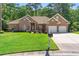 Beautiful brick home featuring a well-manicured lawn and a two-car garage and driveway, offering excellent curb appeal at 6572 Wellington Dr., Murrells Inlet, SC 29576