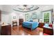 Elegant main bedroom with hardwood floors, tray ceilings, and ensuite bath with a double vanity at 6572 Wellington Dr., Murrells Inlet, SC 29576