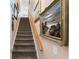Carpeted stairway featuring detailed artwork and natural wood trim at 6572 Wellington Dr., Murrells Inlet, SC 29576