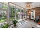 Relaxing sunroom with a skylight, brick accent wall, and a view of the wooded backyard at 6572 Wellington Dr., Murrells Inlet, SC 29576