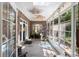 Bright sunroom with many windows, brick accents, and light-colored wood floors at 6572 Wellington Dr., Murrells Inlet, SC 29576